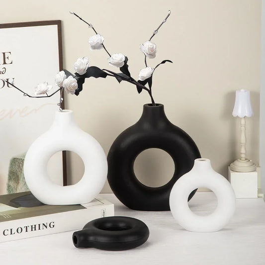 A Circular, Donut-Shaped Plastic Vase For Single Flower Arrangements And Home Decoration.